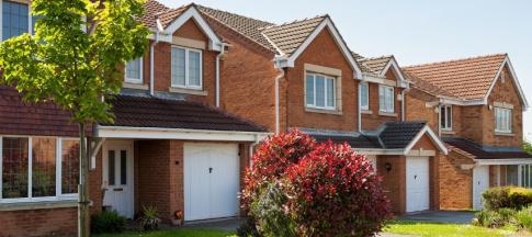 A row of terraced houses with trees at the front