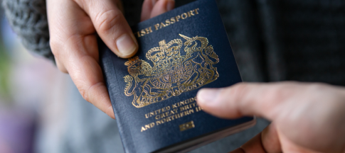 person handing their passport to someone else