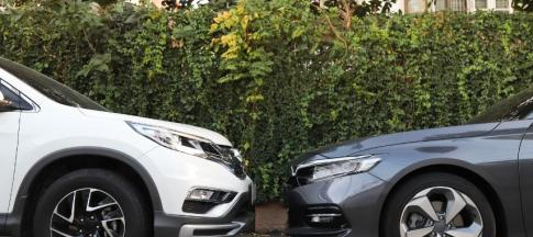 One grey and one white car facing each other
