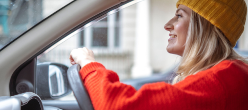 woman driving in car wearing jumper