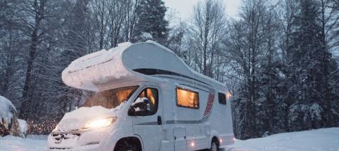 A white campervan in the snow