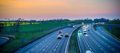 View of a UK motorway, with sunrise in the background