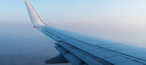 image of plane wing in sky