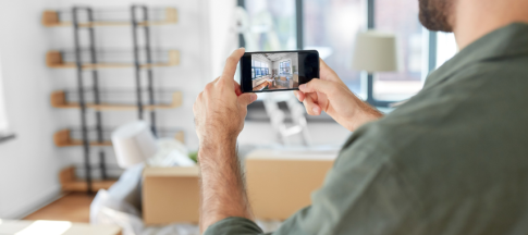 Man taking a picture of his home